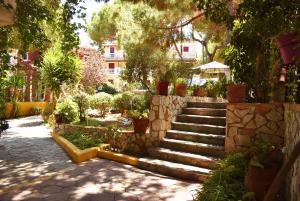 a set of stairs in a garden with potted plants at Kuris Studios & Apartments in Vasilikos