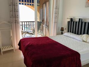 a bedroom with a bed with a view of a balcony at Sunny Escape by the Sea & Yacht Club in Altea