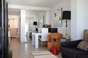 a living room with a table and a dining room at Sunny Escape by the Sea & Yacht Club in Altea