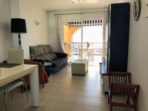 a living room with a couch and a table at Sunny Escape by the Sea & Yacht Club in Altea