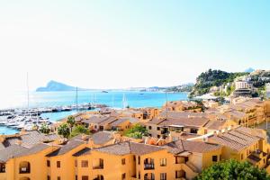 a view of a harbor with houses and boats at Sunny Escape by the Sea & Yacht Club in Altea
