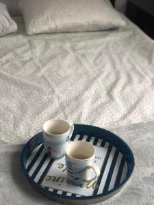 two cups of coffee on a tray on a bed at Noclegi Jachtklub Elbląg in Elblag