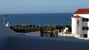 a view of the ocean from a balcony of a house at Hotel Baleal Spot in Baleal
