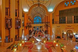 a large lobby with a large vase with flowers in it at Carthage Thalasso Resort in Gammarth