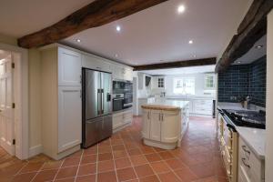 a kitchen with white appliances and a tile floor at Heron House at Millfields Farm Cottages in Hognaston