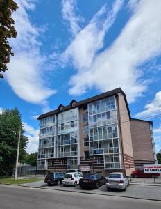 a large building with cars parked in front of it at New Lux apartment 2020 in Kharkiv