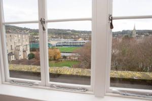 an open window with a view of a city at Spectacular views, 1 Bed Central Bath Apartment in Bath