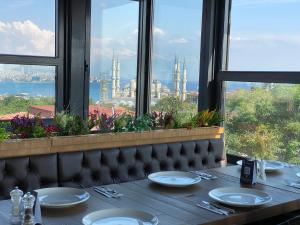 a table in a restaurant with a view of the city at AHC Ayasofya Hotel in Istanbul