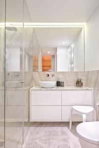 a white bathroom with a sink and a shower at Liiiving in Porto - Santa Catarina Boutique in Porto