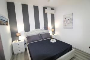 Ένα ή περισσότερα κρεβάτια σε δωμάτιο στο Lugana Family Apartment