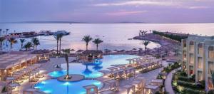 an aerial view of a resort with a pool and the ocean at JAZ Elite Casa Del Mar Beach in Hurghada