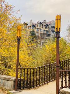two lights on a bridge with a building in the background at Sunny Apartment Dilijan in Dilijan
