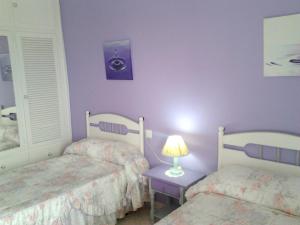 A bed or beds in a room at Modern Apartment in Nerja with Sea View, 90 sqm