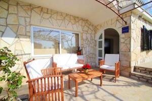 a patio with two chairs and a table and a bench at Charming Apartment in Novigrad, 45 sqm, with Terrace in Novigrad Istria