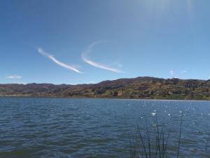 a large body of water with mountains in the background at Madervill Hospedaje in Aquitania +12 photos