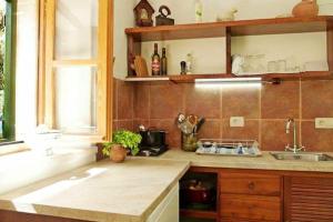 a kitchen with a counter and a sink and a window at Charming House Selca + BBQ in Selca +25 photos