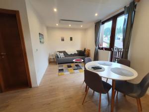 a living room with a table and a couch at Jelka apartmani in Jahorina
