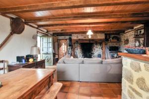 a living room with a couch and a table at Maison de 3 chambres avec jardin amenage et wifi a Senezergues in Sénezergues