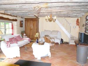 a living room with white furniture and a staircase at Maison d'une chambre avec piscine privee jardin amenage et wifi a Sainte Alvere in Saint-Alvère