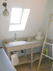 a bathroom with a sink and a window at Maison de charme avec piscine privée à Sainte-Alvère in Saint-Alvère
