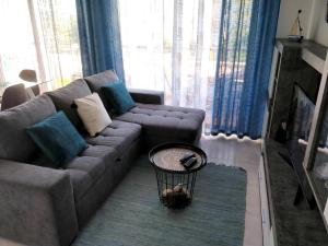 a living room with a couch and a table at Sea View Apartment - Portimão - Balcony in Portimão