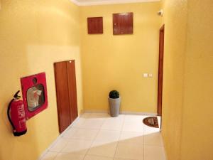 a hallway with yellow walls and a potted plant at Sea View Apartment - Portimão - Balcony in Portimão +12 photos