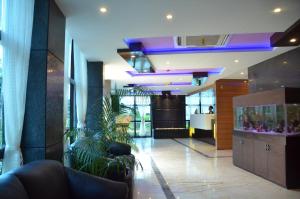 a lobby with plants in the middle of a building at The Dolphin Palace in Chandannagar