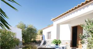 een wit huis met een binnenplaats met een tafel bij 2 bedrooms chalet with lake view furnished terrace and wifi at El Gastor in El Gastor