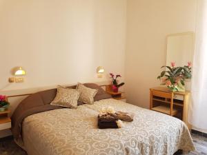 a bedroom with a bed with a purse on it at HOTEL ROMANTICA in Rimini