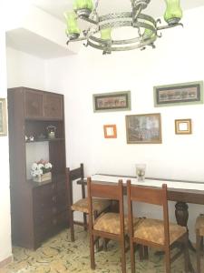 a dining room with a table and chairs and a chandelier at 4 bedrooms house with terrace and wifi at Albunol 7 km away from the beach in Albuñol