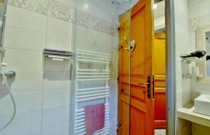 a bathroom with a shower and a glass door at Maison de 4 chambres avec jardin clos et wifi a Cauterets a 2 km des pistes in Cauterets