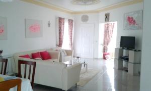 a living room with a white couch and a table at Elegant Villa in Albufeira with Private Pool. in Albufeira