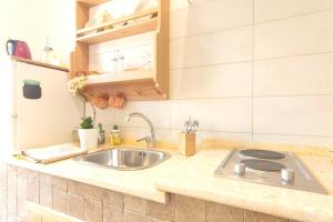 a kitchen with a sink and a counter top at One bedroom appartement with terrace and wifi at Marsala 5 km away from the beach in Marsala