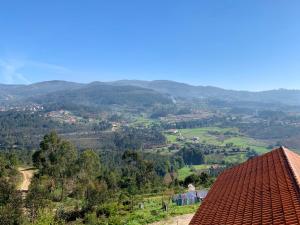 a view of a valley with a red roof at 9 bedrooms villa with private pool jacuzzi and enclosed garden at Ponte de Lima Viana do Castelo in Ponte de Lima