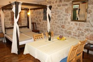 a room with a table with a bottle of wine and a bed at Charming Studio in Betina, 30 m², Terrace in Betina