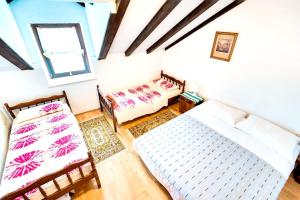 a living room with two beds and a couch at One bedroom apartement at Zlarin 200 m away from the beach with sea view enclosed garden and wifi in Zlarin