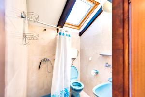 a bathroom with a toilet and a shower curtain at One bedroom appartement at Zlarin 200 m away from the beach with sea view enclosed garden and wifi in Zlarin