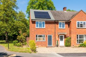 a red brick house with solar panels on the roof at 2 bed house close to Town Centre in Bracknell