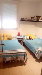 two beds sitting next to each other in a room at Modern Apartment in Calafell + Terrace in Calafell