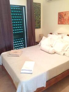 a bedroom with a bed with a book on it at Modern house in Altura with terrace and city view in Altura