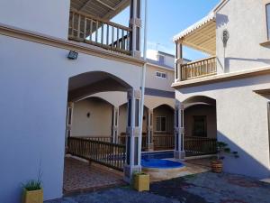 an external view of a house with a swimming pool at Villa Retreat in Flic en Flac with Private Pool in Flic-en-Flac