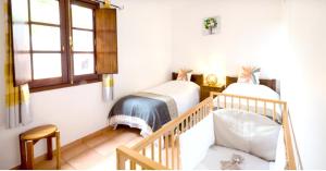 two twin beds in a room with a staircase at 2 bedrooms house with furnished garden and wifi at Camacha in Camacha