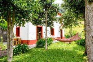 a hammock in the garden of a house at 2 bedrooms house with furnished garden and wifi at Camacha in Camacha