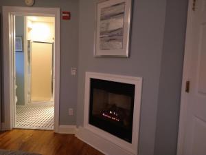 a living room with a fireplace and a hallway at Tandem Bike Inn in Belmar