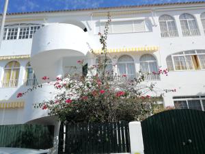 un edificio blanco con una maceta delante de él en 3 bedrooms apartement with city view shared pool and terrace at El Portil 1 km away from the beach, en El Portil