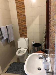 バリートにあるMiniMap Cozy Cottageの白いトイレと洗面台のあるバスルーム +3枚の写真