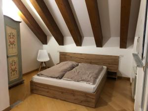 a bedroom with a bed in a room with wooden ceilings at Casa Giant Santa Maria Maggiore - Locazione Turistica in Santa Maria Maggiore +51 photos
