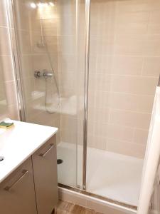 a shower with a glass door in a bathroom at Studio avec balcon amenage et wifi a Vars in Vars