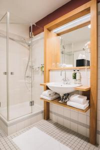 a bathroom with a sink and a shower at Hotel Kloster Eberbach in Eltville