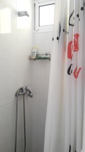 a bathroom with a shower with a shower curtain at One bedroom appartement with sea view furnished terrace and wifi at Funchal 6 km away from the beach in Funchal